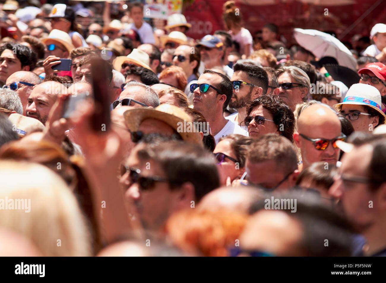 Man taking photos of the procession using mobile phone. Stock Photo