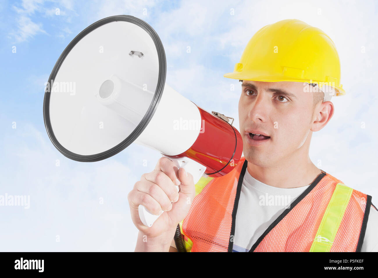 Construction foreman outdoors giving orders on megaphone Stock Photo