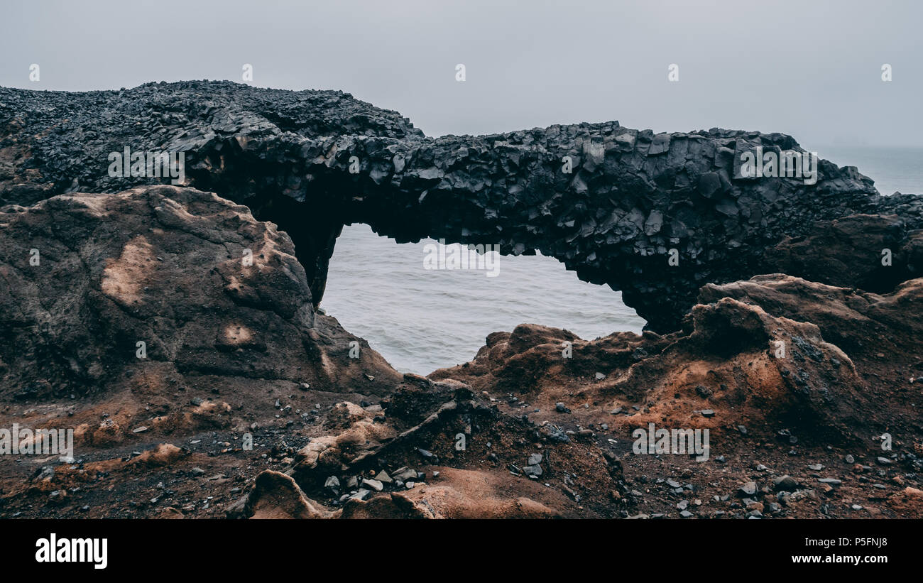 black basalt rock bridge in iceland. hexagon stone bridge in vik, black stone Stock Photo
