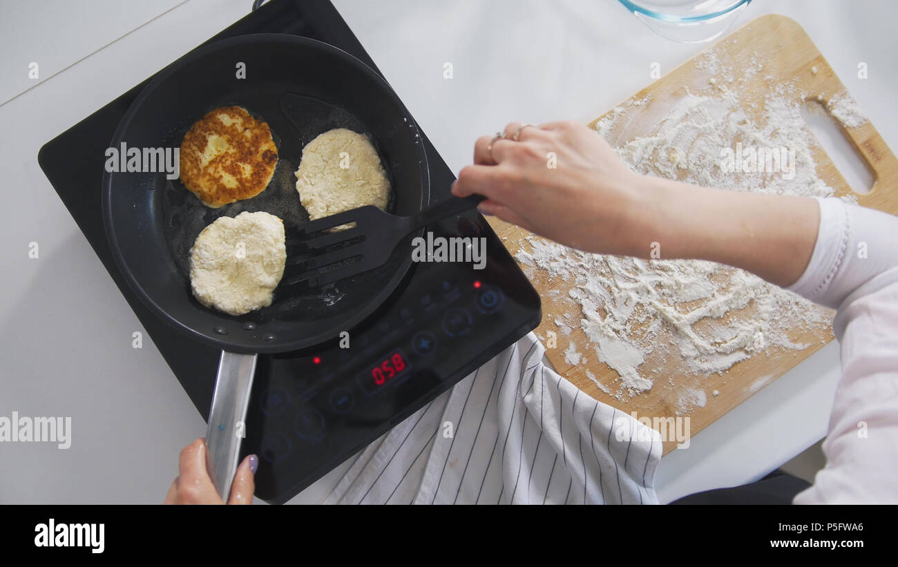 Female Hands Fries In The Pan Homemade Cottage Cheese Pancakes