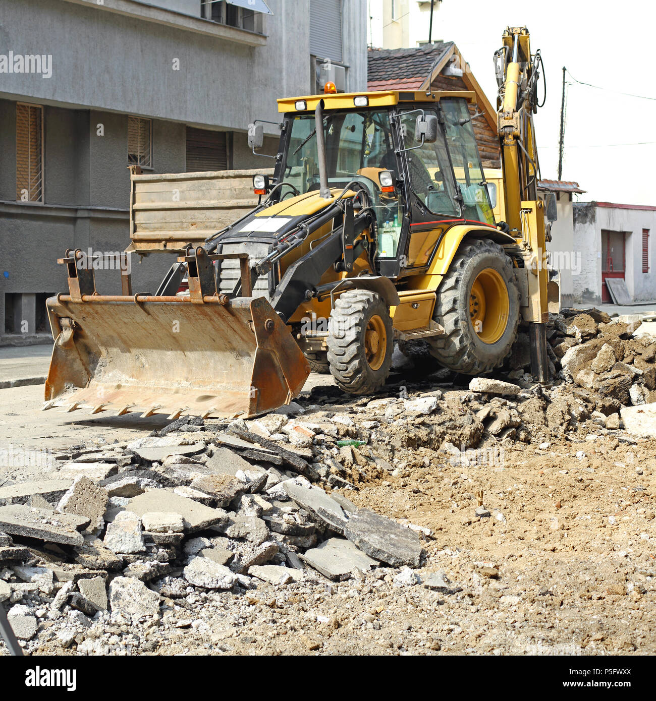 Backhoe Loader Digging Street at Construction Site Stock Photo Alamy