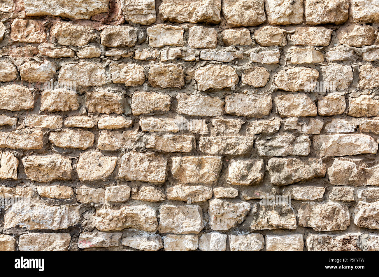Weathered grey stone wall as creative background texture Stock Photo