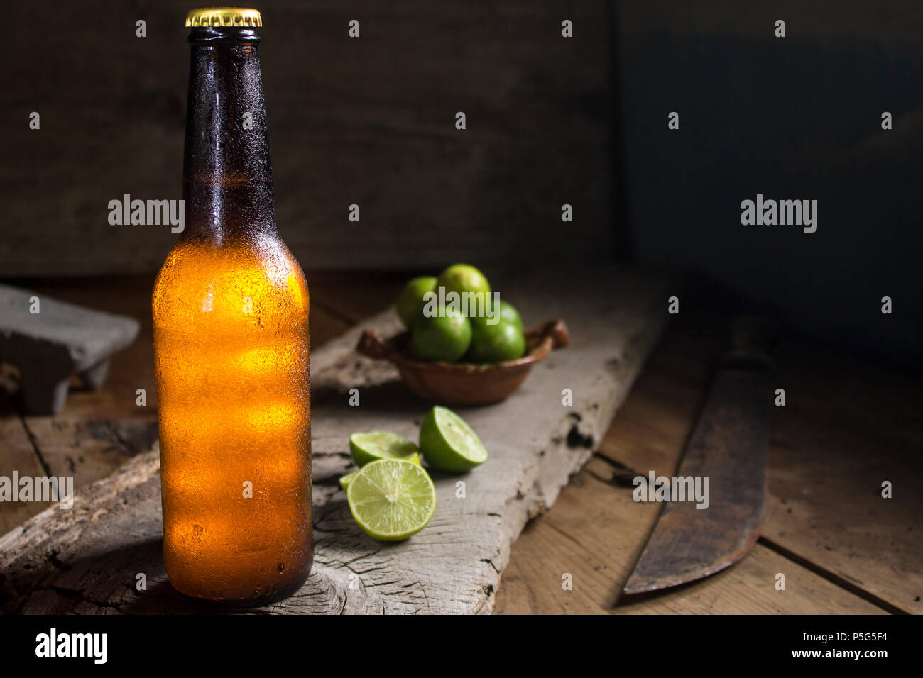 chill beer and lemons on a rustic wood table, machete, mexico Stock ...