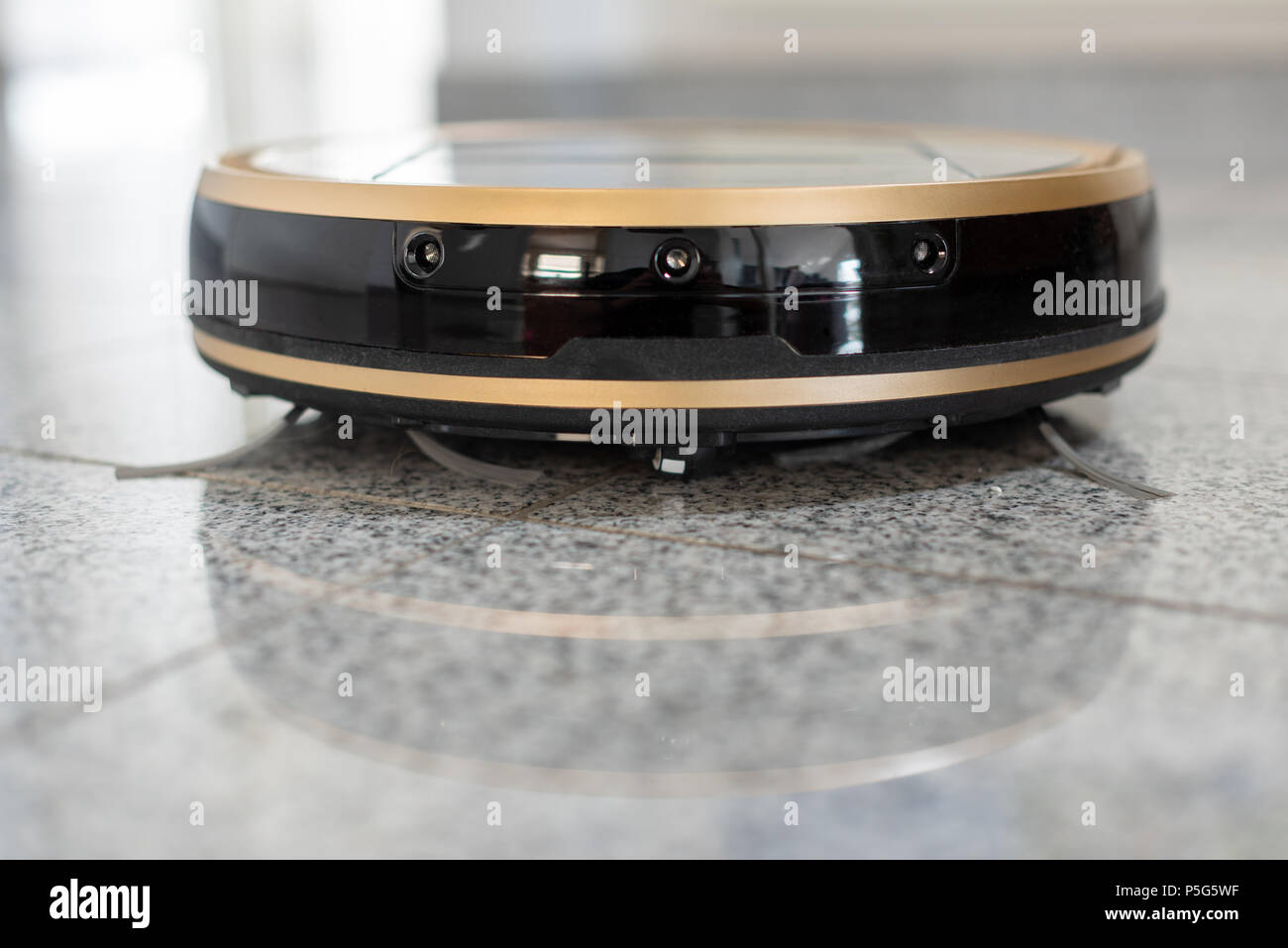 Robotic vacuum cleaner on bright marble floor Stock Photo Alamy