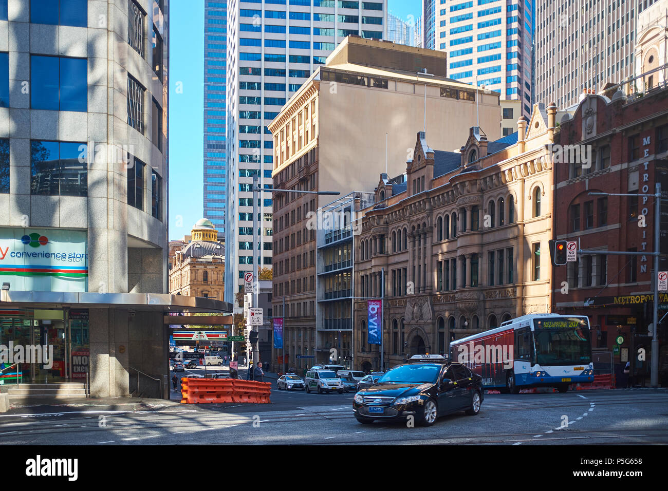 A view of Bridge Street from George Street in the early morning sun with traffic showing the old and new buildings of Sydney, NSW, Australia Stock Photo