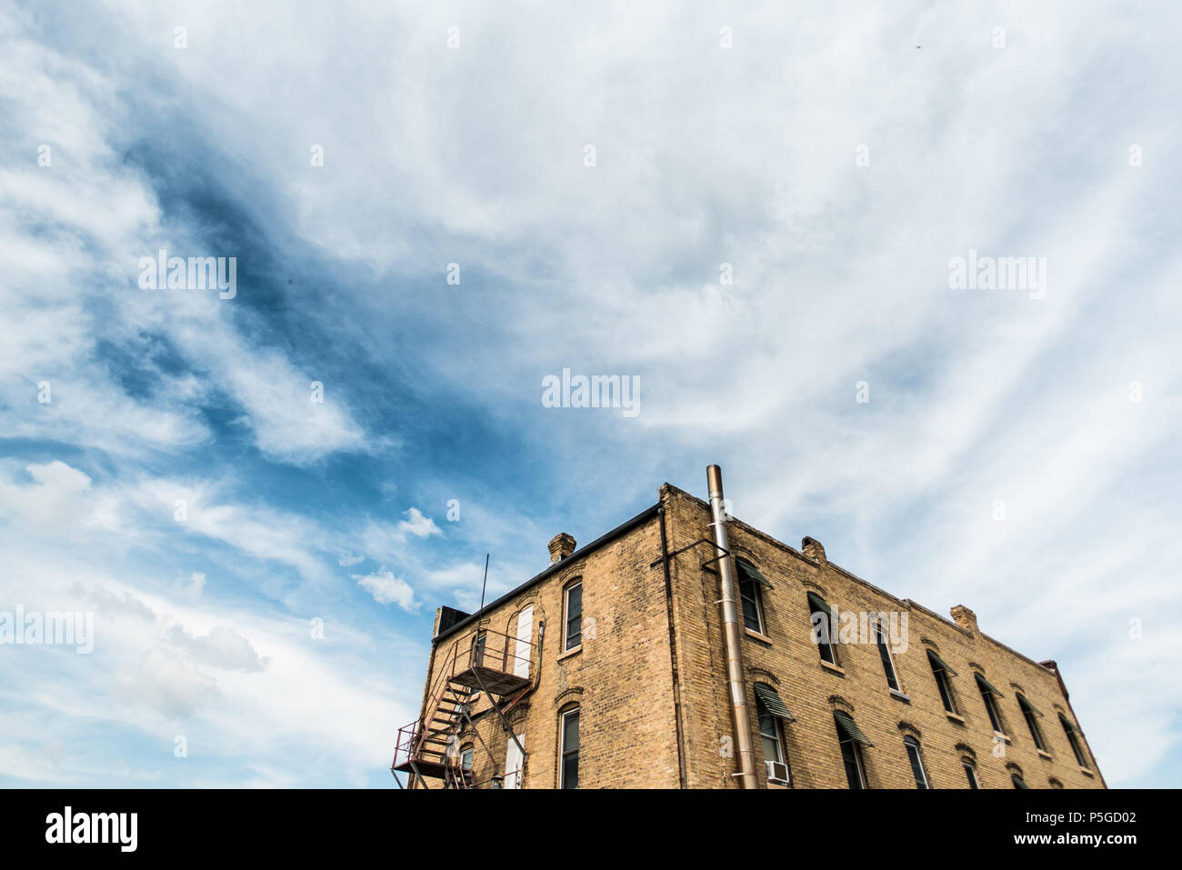 Small, old apartment building with visible fire escape in a small town