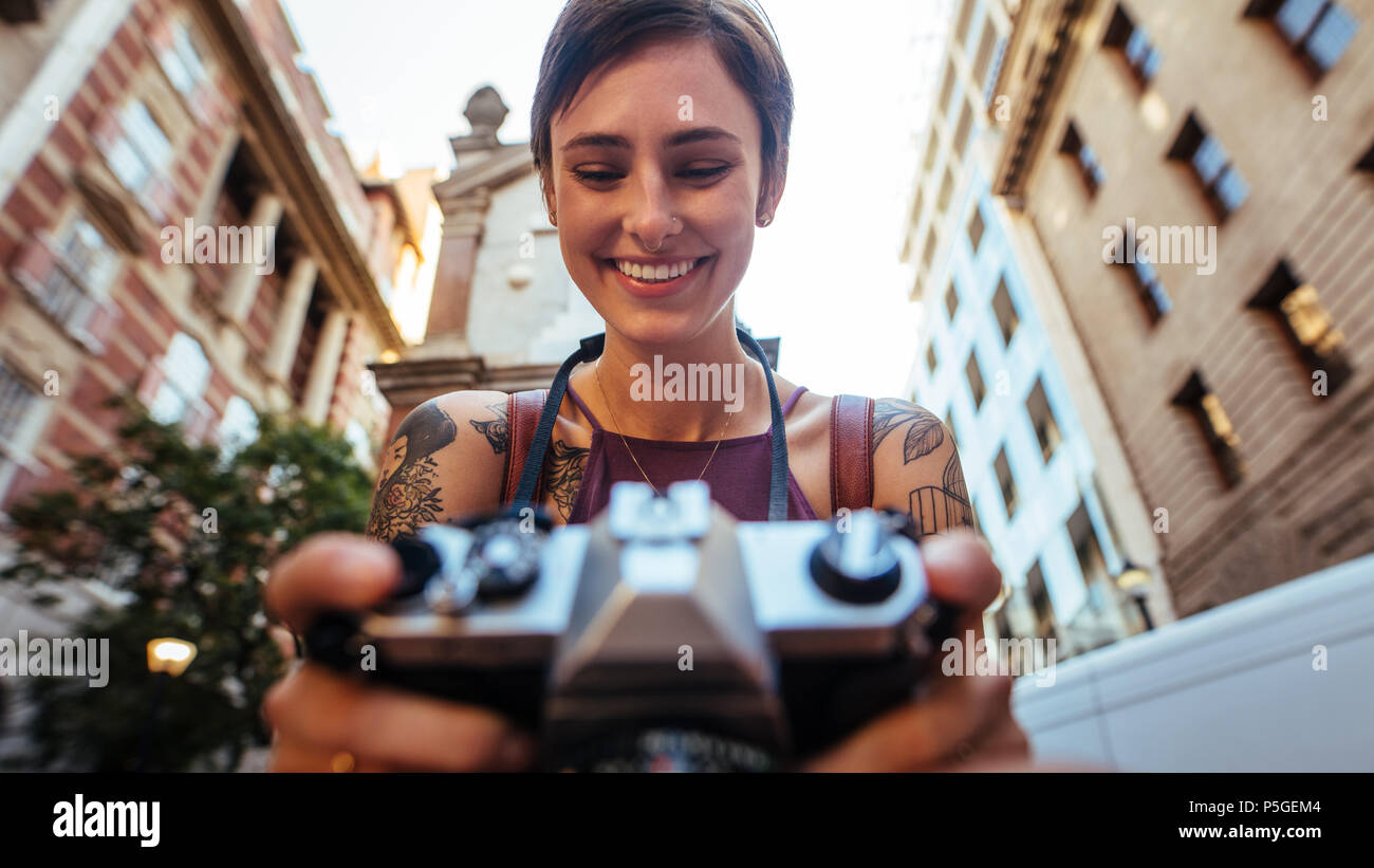 Close Up Of A Smiling Woman Tourist Taking Photograph Using A