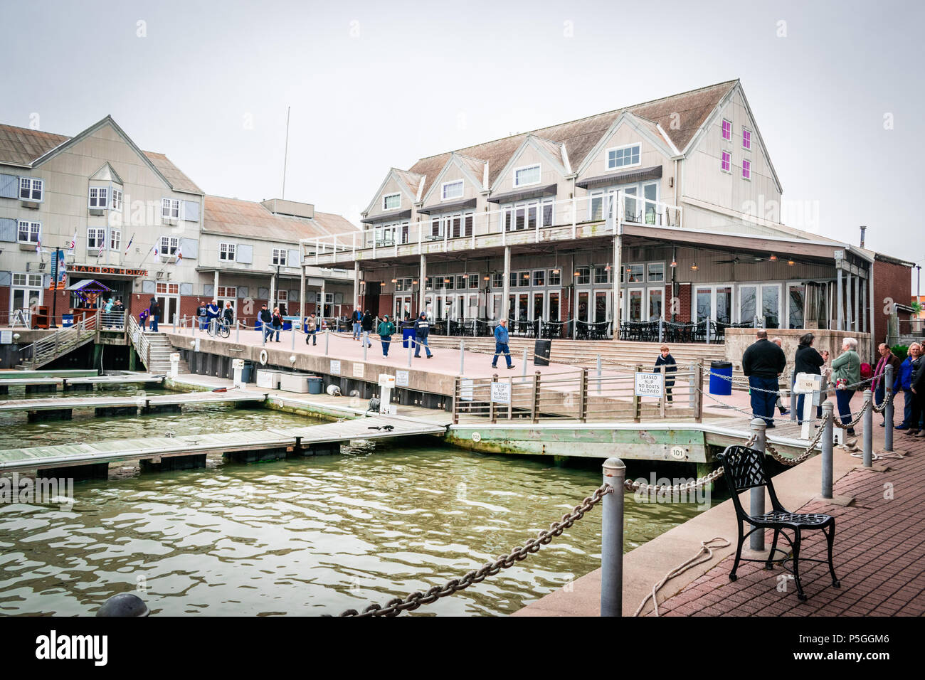 Wharf in Galveston, Texas, Pier 21 fills with people on a cold and rainy day to see the tall