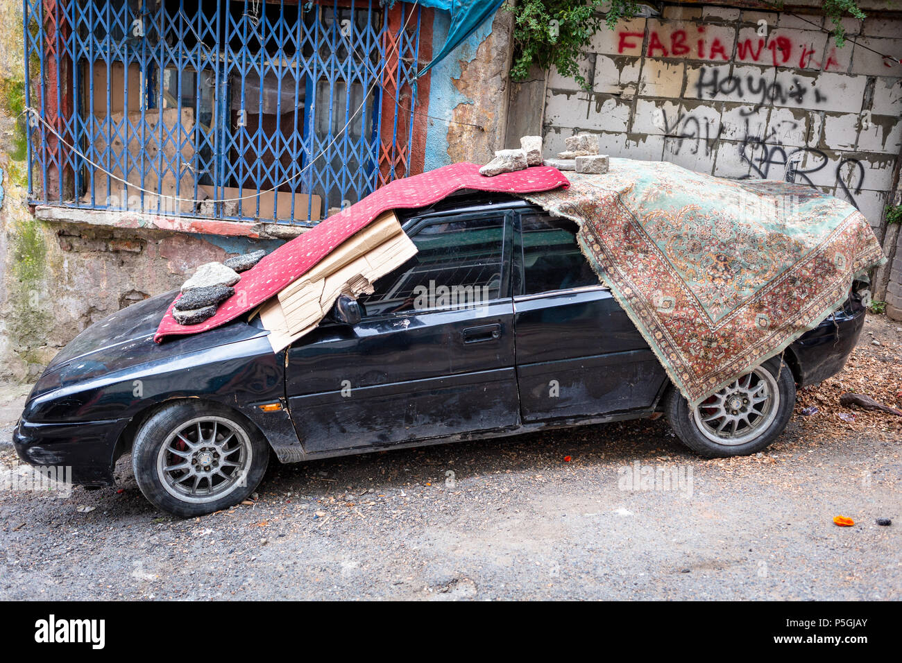 Residents prepare for the storm by covering their cars with blankets or protective materials expect strong thunder, heavy hail in Istanbul, Turkey. Stock Photo