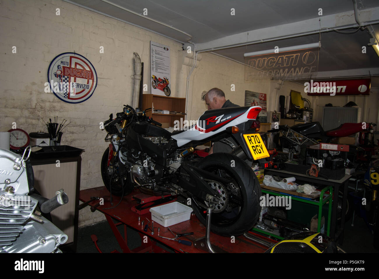 Ducati Motor Bikes working old style type person repairing bike bikes