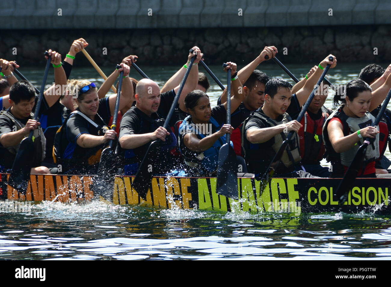 Dragon boat festival rowers, rowing to the finish line. Stock Photo
