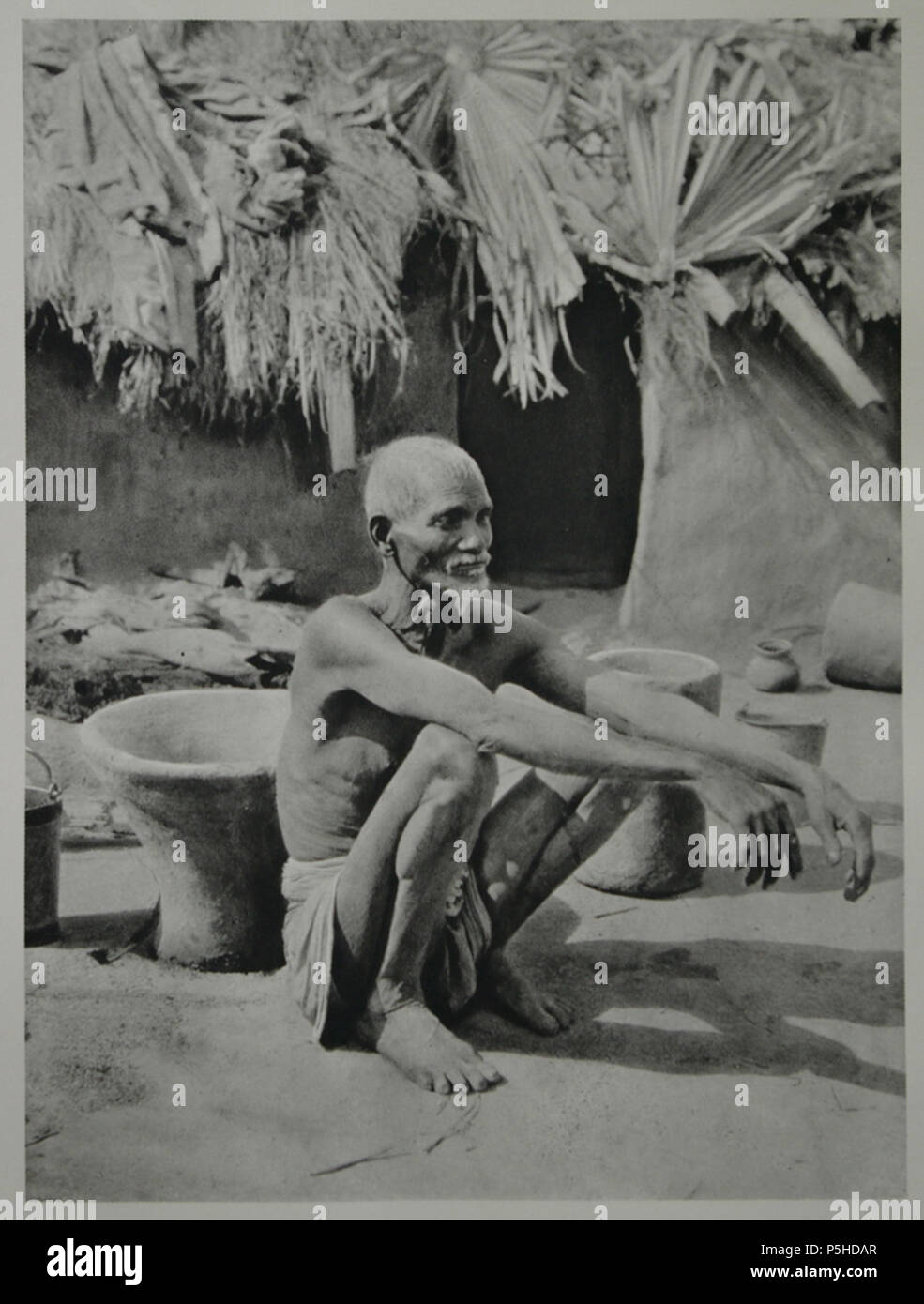 N/A. English: A poor man sitting in front of his hut in Patna. 1927 ...