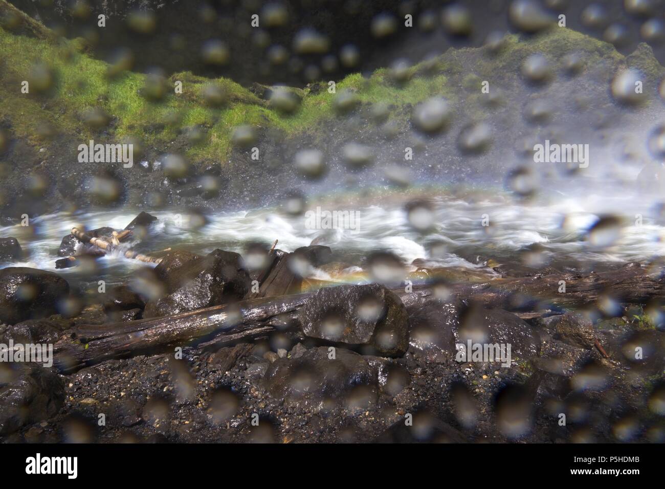 Water Drops Spray collecting on wet digital photography camera lens creating surreal blurred liquid background effect Stock Photo