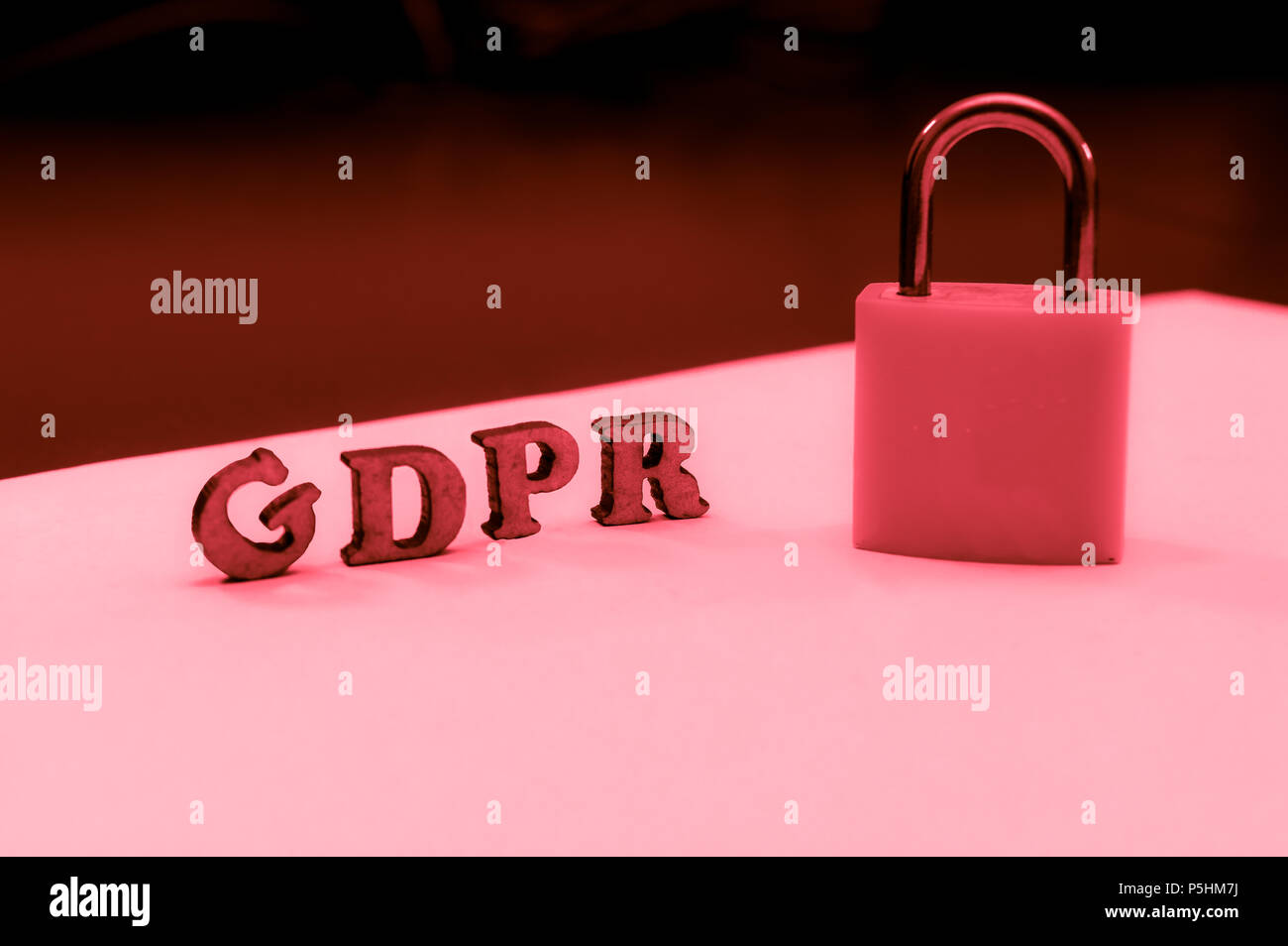 GDPR letters next to a lock on a red colored image indicating failure Stock Photo