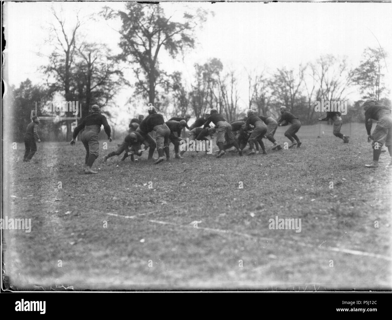 N/A. English: Persistent URL: digital.lib.muohio.edu/u/snyder,3643 Subject (TGM): Football; Football players; Sports; Universities and colleges; Location: Oxford, Ohio  . 1911. Snyder, Frank R. Flickr: Miami U. Libraries - Digital Collections 57 Action at Miami-Wilmington football game 1911 (3195535930) Stock Photo