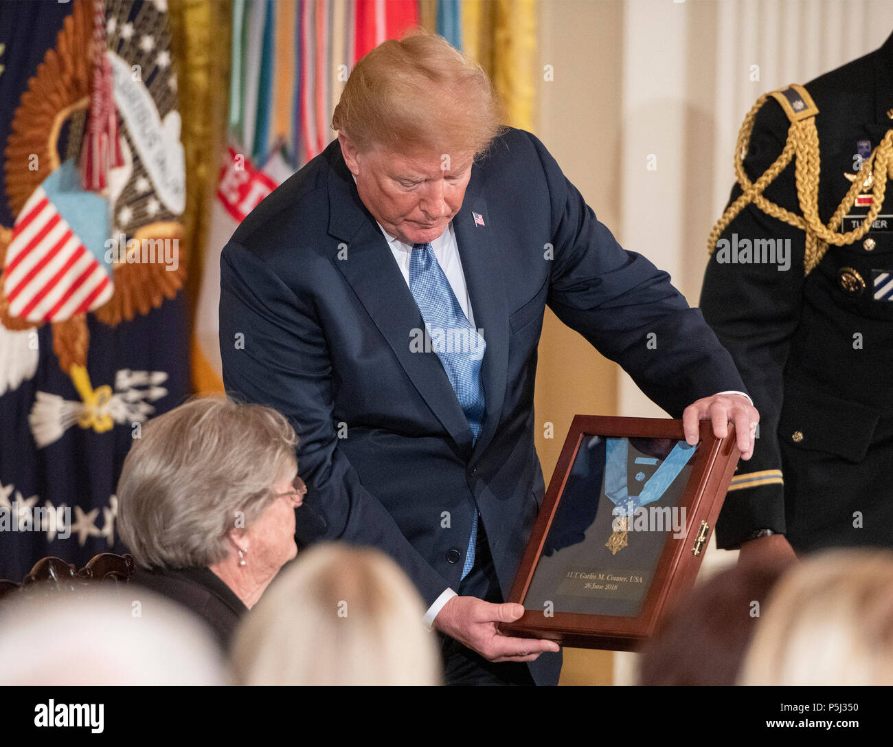 United States President Donald J. Trump presents the Medal of Honor to Pauline Conner, widow of then-First Lieutenant Garlin M. Conner, U.S. Army, who is receiving the honor for conspicuous gallantry during World War II in the East Room of the White House in Washington, DC on Tuesday, June 26, 2018. Conner is being honored for his actions on January 24,1945, while serving as an intelligence officer with Headquarters and Headquarters Company, 3d Battalion, 7th Infantry Regiment, 3d Infantry Division. Credit: Ron Sachs/CNP /MediaPunch Stock Photo