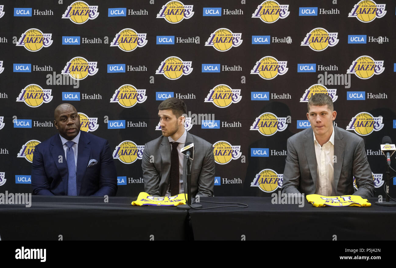 Los Angeles, California, USA. 26th June, 2018. Los Angeles Lakers president  of basketball operations, Earvin ''Magic'' Johnson, center, rookies  Sviatoslav Mykhailiuk, right, and Moritz Wagner pose with their new jerseys  at an