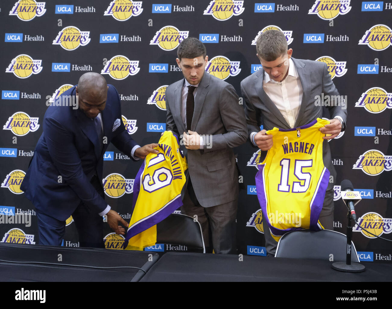 Los Angeles, California, USA. 26th June, 2018. Los Angeles Lakers president of basketball operations, Earvin ''Magic'' Johnson, left, rookies Sviatoslav Mykhailiuk, center, and Moritz Wagner pose with their new jerseys at an introductory press conference in Los Angeles, Tuesday, June 26, 2018. The Lakers introduce two new draft players, Moritz Wagner, originally from Germany, the 25th pick in the 2018 NBA Draft and guard Sviatoslav Mykhailiuk, originally from Ukraine. Credit: Ringo Chiu/ZUMA Wire/Alamy Live News Stock Photo