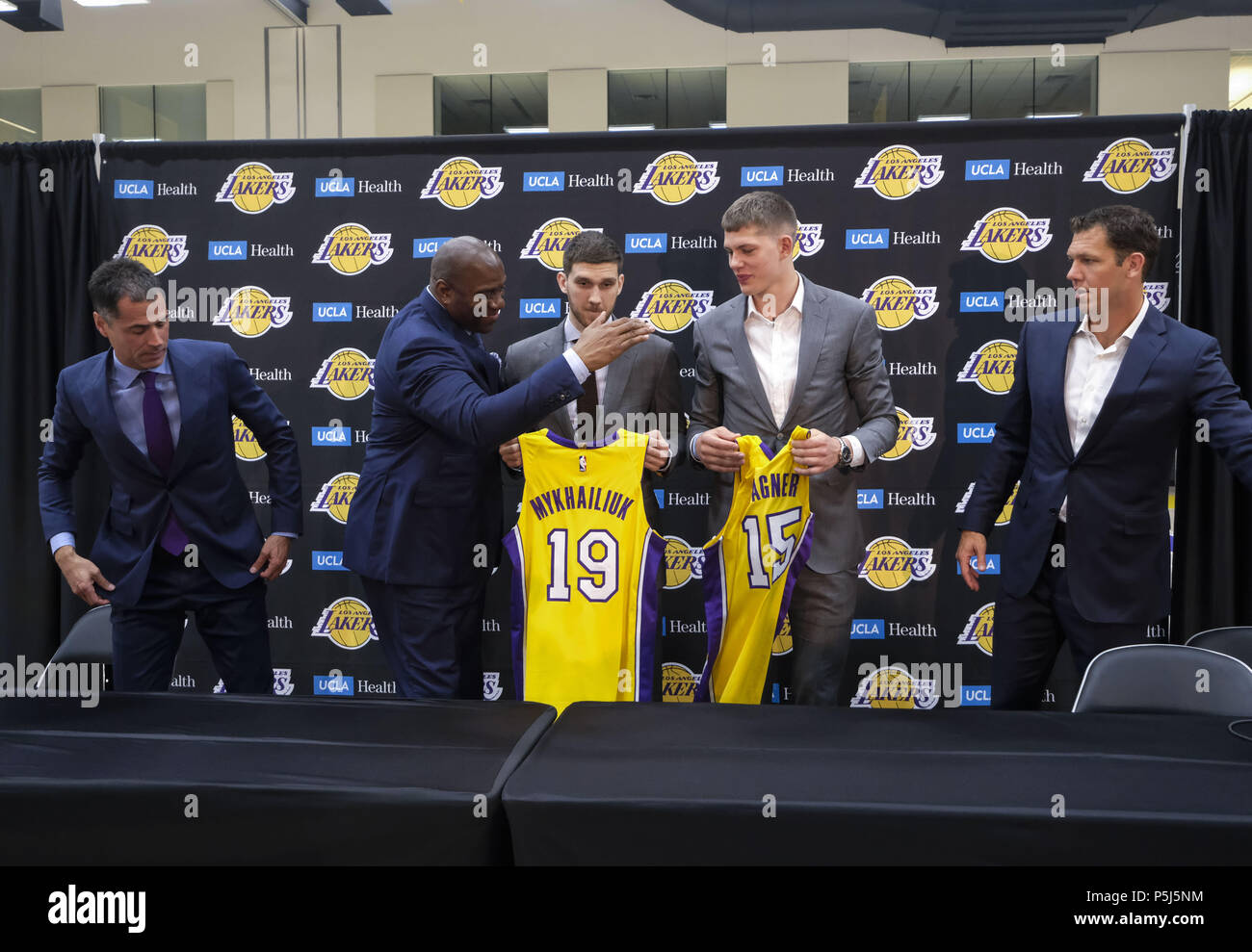 Los Angeles, California, USA. 26th June, 2018. From L to R, Los Angeles  Lakers general manager Rob Pelinka, president of basketball operations,  Earvin ''Magic'' Johnson, rookies Sviatoslav Mykhailiuk, Moritz Wagner and  head