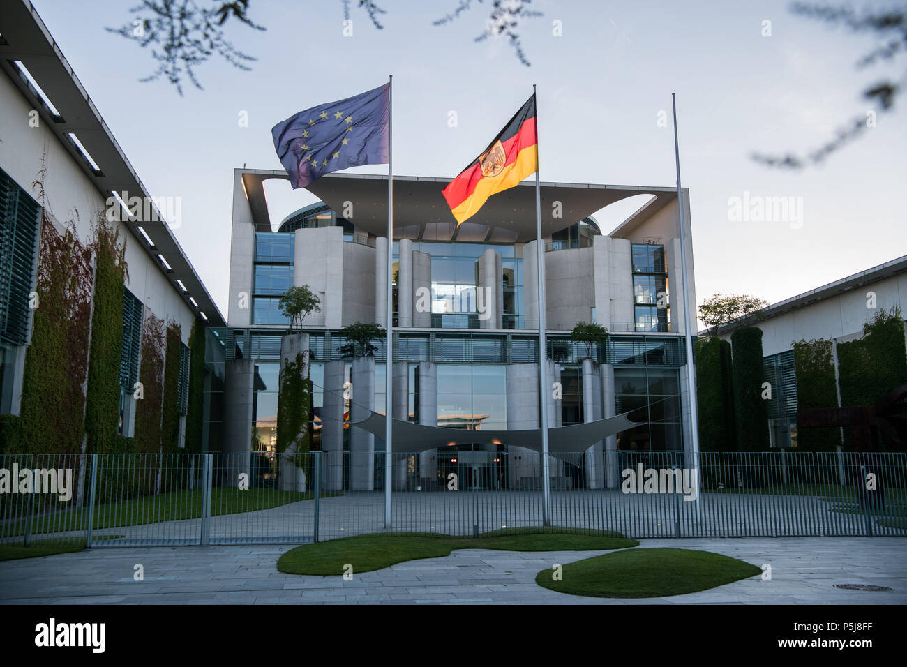 Berlin, Germany. 26th June, 2018. The German and the European flags blowing in the wind in front of the Federal Chancellery during the coalition summit meeting. Credit: Bernd von Jutrczenka/dpa/Alamy Live News Stock Photo
