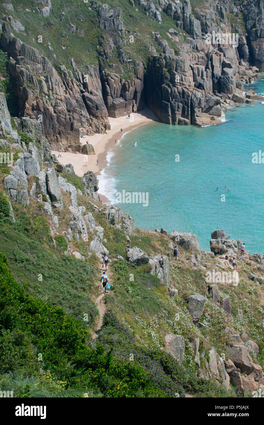 Treen, Cornwall, UK. 27th June 2018. UK Weather. On the hottest day of the year so far, people were making the most of the secluded beach at Treen, near Porthcurno in Cornwall. Credit: cwallpix/Alamy Live News Stock Photo
