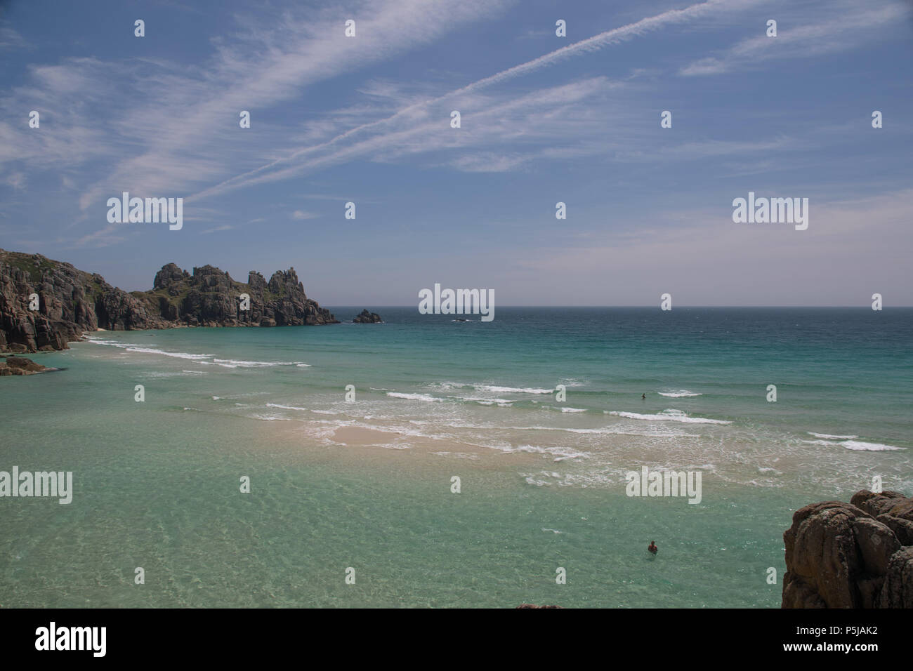 Treen, Cornwall, UK. 27th June 2018. UK Weather. On the hottest day of the year so far, people were making the most of the secluded beach at Treen, near Porthcurno in Cornwall. Credit: cwallpix/Alamy Live News Stock Photo