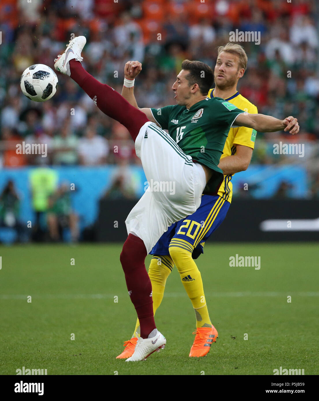 Yekaterinburg, Russia. 27th June, 2018. Hector Herrera (front) of Mexico competes during the 2018 FIFA World Cup Group F match between Mexico and Sweden in Yekaterinburg, Russia, June 27, 2018. Credit: Li Ming/Xinhua/Alamy Live News Stock Photo