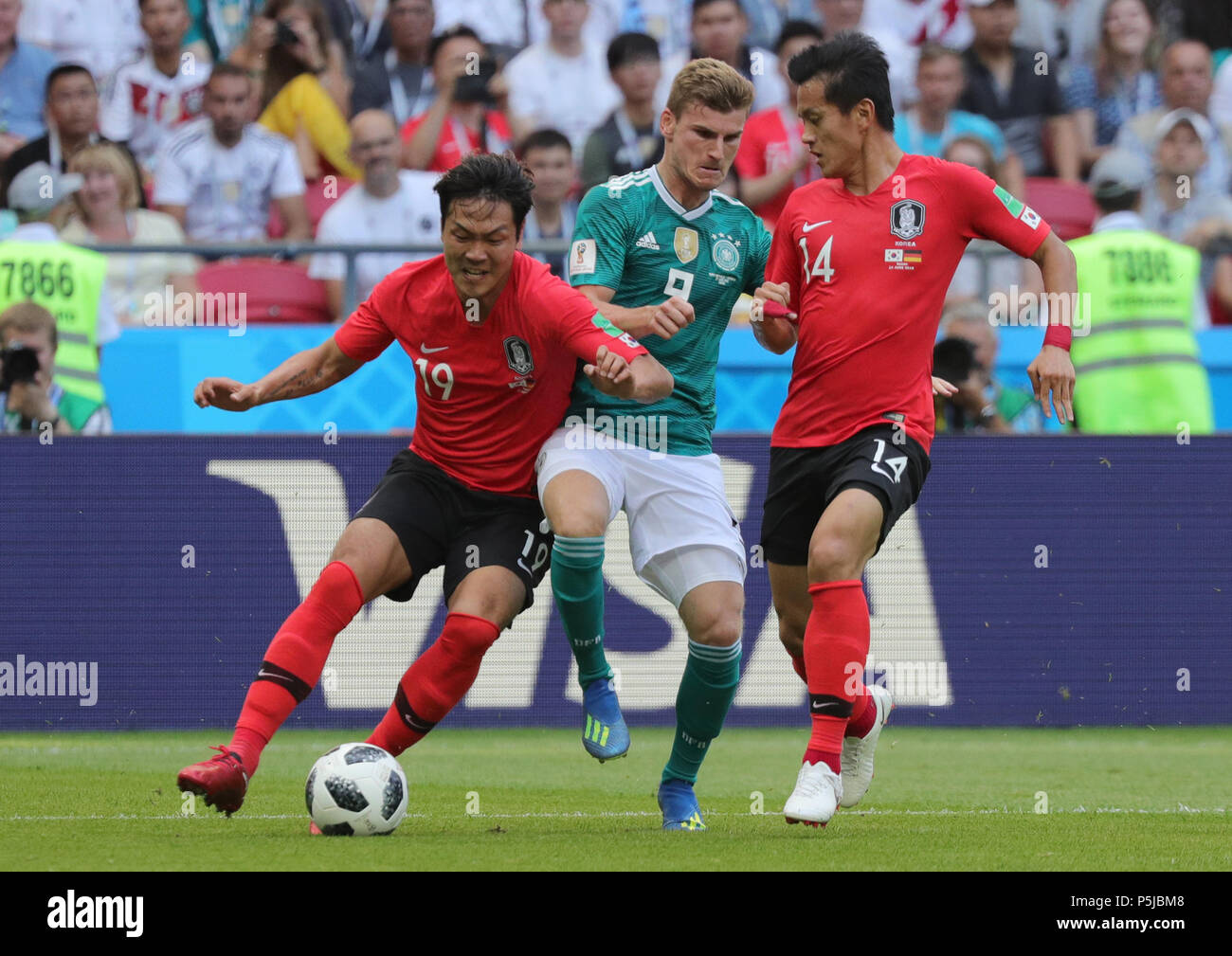 Kazan, Russia. 27th June, 2018. Soccer, FIFA World Cup, group F preliminary, Germany vs South Korea at the Kazan-Arena. Germany's Timo Werner (c) and South Korea's Young-Gwon Kim (l). Credit: Christian Charisius/dpa/Alamy Live News Stock Photo