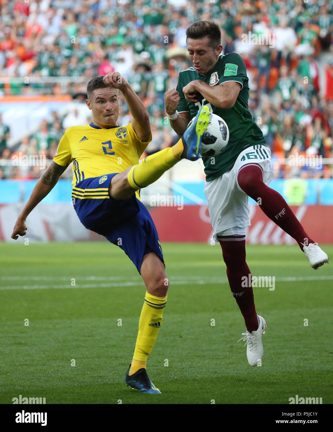 Yekaterinburg, Russia. 27th June, 2018. Hector Herrera (R) of Mexico vies with Mikael Lustig of Sweden during the 2018 FIFA World Cup Group F match between Mexico and Sweden in Yekaterinburg, Russia, June 27, 2018. Credit: Li Ming/Xinhua/Alamy Live News Stock Photo