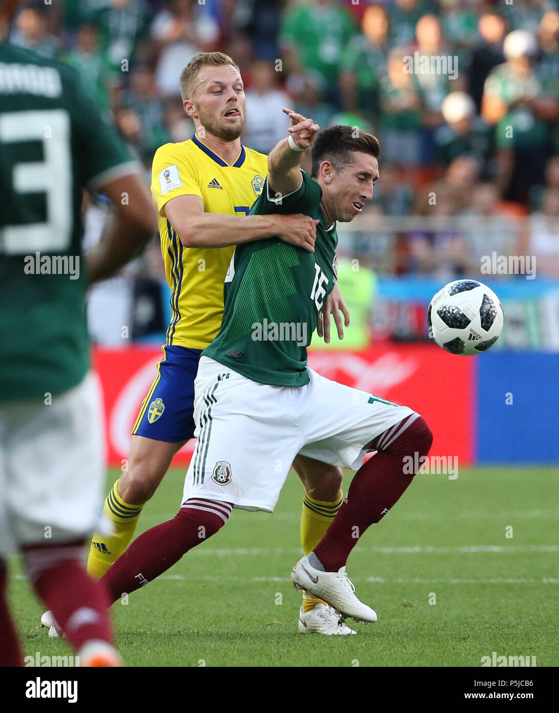 Yekaterinburg, Russia. 27th June, 2018. Hector Herrera (R) of Mexico vies with Sebastian Larsson of Sweden during the 2018 FIFA World Cup Group F match between Mexico and Sweden in Yekaterinburg, Russia, June 27, 2018. Credit: Li Ming/Xinhua/Alamy Live News Stock Photo