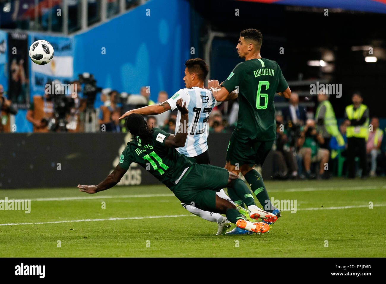 St Petersburg, Russia, 27 June 2018. Maximiliano Meza of Argentina is tackled by Victor Moses of Nigeria and Leon Balogun of Nigeria during the 2018 FIFA World Cup Group D match between Nigeria and Argentina at Saint Petersburg Stadium on June 26th 2018 in Saint Petersburg, Russia. (Photo by Daniel Chesterton/phcimages.com) Credit: PHC Images/Alamy Live News Stock Photo