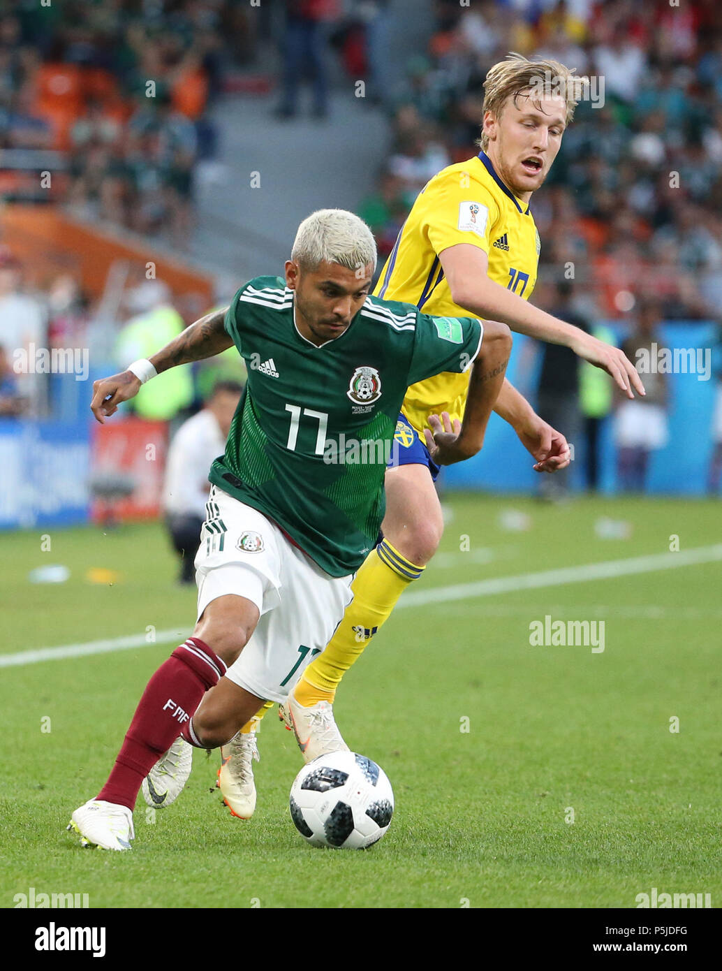 Yekaterinburg, Russia. 27th June, 2018. Jesus Corona (bottom) of Mexico vies with Emil Forsberg of Sweden during the 2018 FIFA World Cup Group F match between Mexico and Sweden in Yekaterinburg, Russia, June 27, 2018. Credit: Li Ming/Xinhua/Alamy Live News Stock Photo