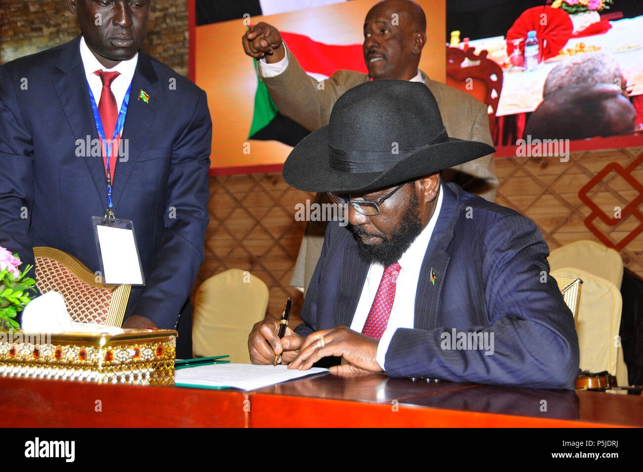 Khartoum, South Sudan. 27th June, 2018. South Sudan President Salva Kiir Mayardit signs on a peace deal reached with South Sudan government in Khartoum, South Sudan, June 27, 2018. The parties to the conflict in South Sudan on Wednesday signed Khartoum Peace Agreement in South Sudan, including permanent ceasefire taking effect within 72 hours, according to Sudan's Foreign Minister Al-Dirdiri Mohamed Ahmed. Credit: Mohamed Khidir/Xinhua/Alamy Live News Stock Photo