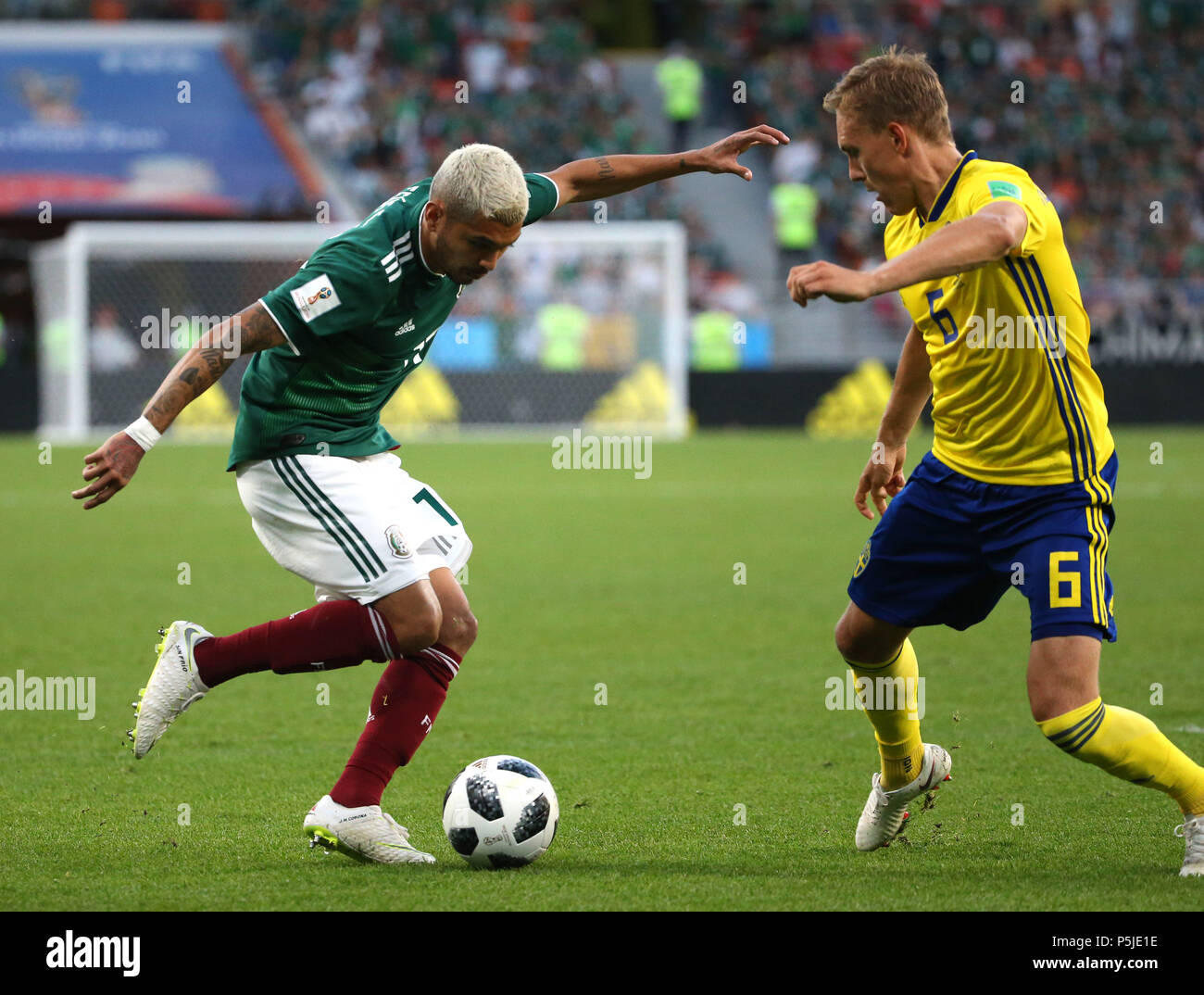 Yekaterinburg, Russia. 27th June, 2018. Jesus Corona (L) of Mexico vies with Ludwig Augustinsson of Sweden during the 2018 FIFA World Cup Group F match between Mexico and Sweden in Yekaterinburg, Russia, June 27, 2018. Sweden won 3-0. Mexico and Sweden advanced to the round of 16. Credit: Li Ming/Xinhua/Alamy Live News Stock Photo