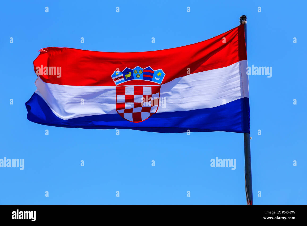 National flag of Croatia flying in blue sky Stock Photo