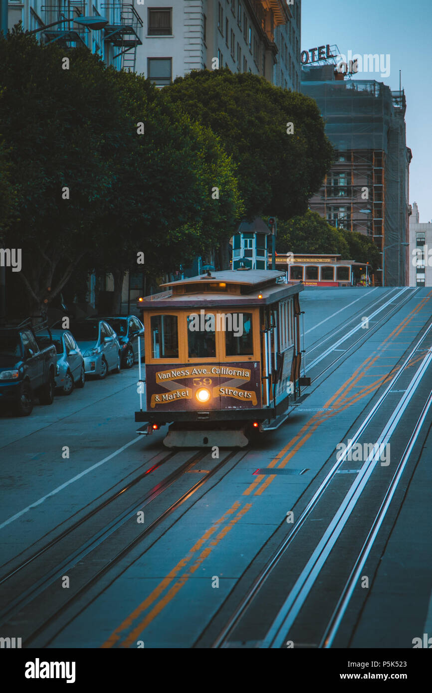 Magical twilight view of historic Cable Car riding on famous California Street at dawn before sunrise, San Francisco, California, USA Stock Photo