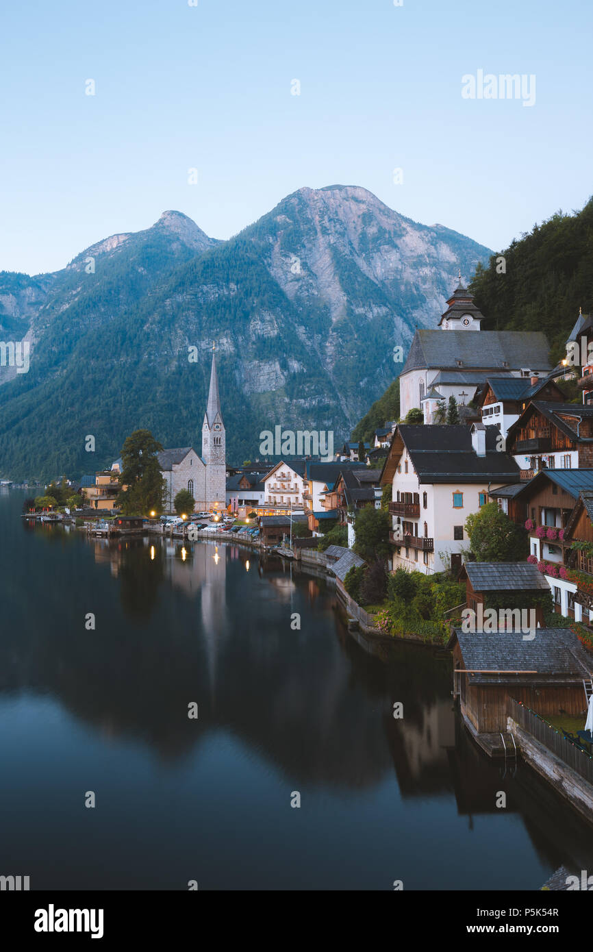 Classic postcard view of famous Hallstatt lakeside town in the Alps in early morning light at dawn with retro film look, Salzkammergut region, Austria Stock Photo