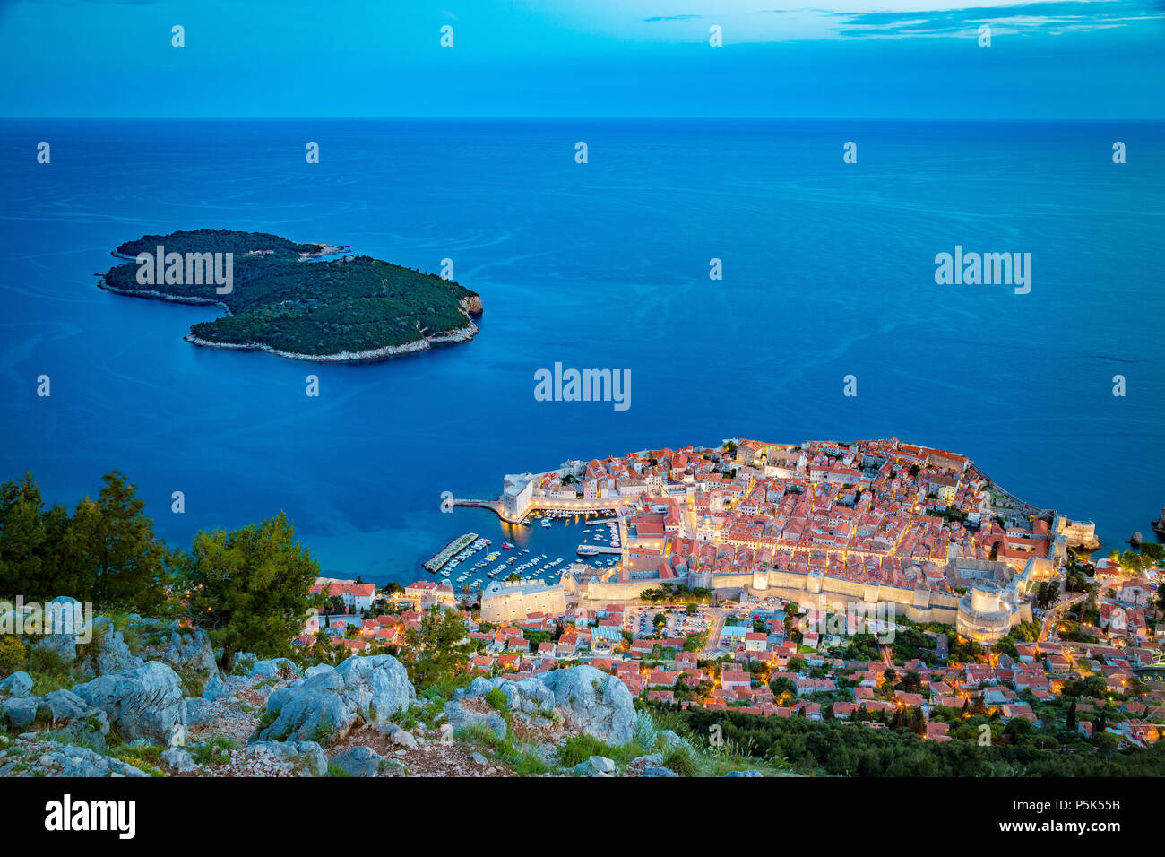 Panoramic aerial view of the historic town of Dubrovnik with Lokrum island in beautiful evening twilight at dusk, Dalmatia, Croatia Stock Photo