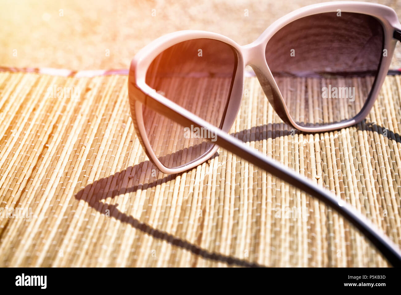 Glasses on the beach sand. Sunglasses on the beach background Stock