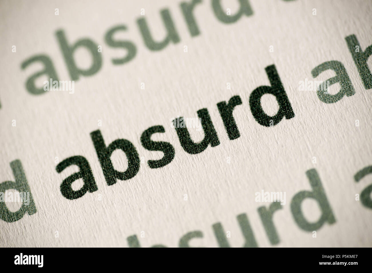 word absurd printed on white paper macro Stock Photo