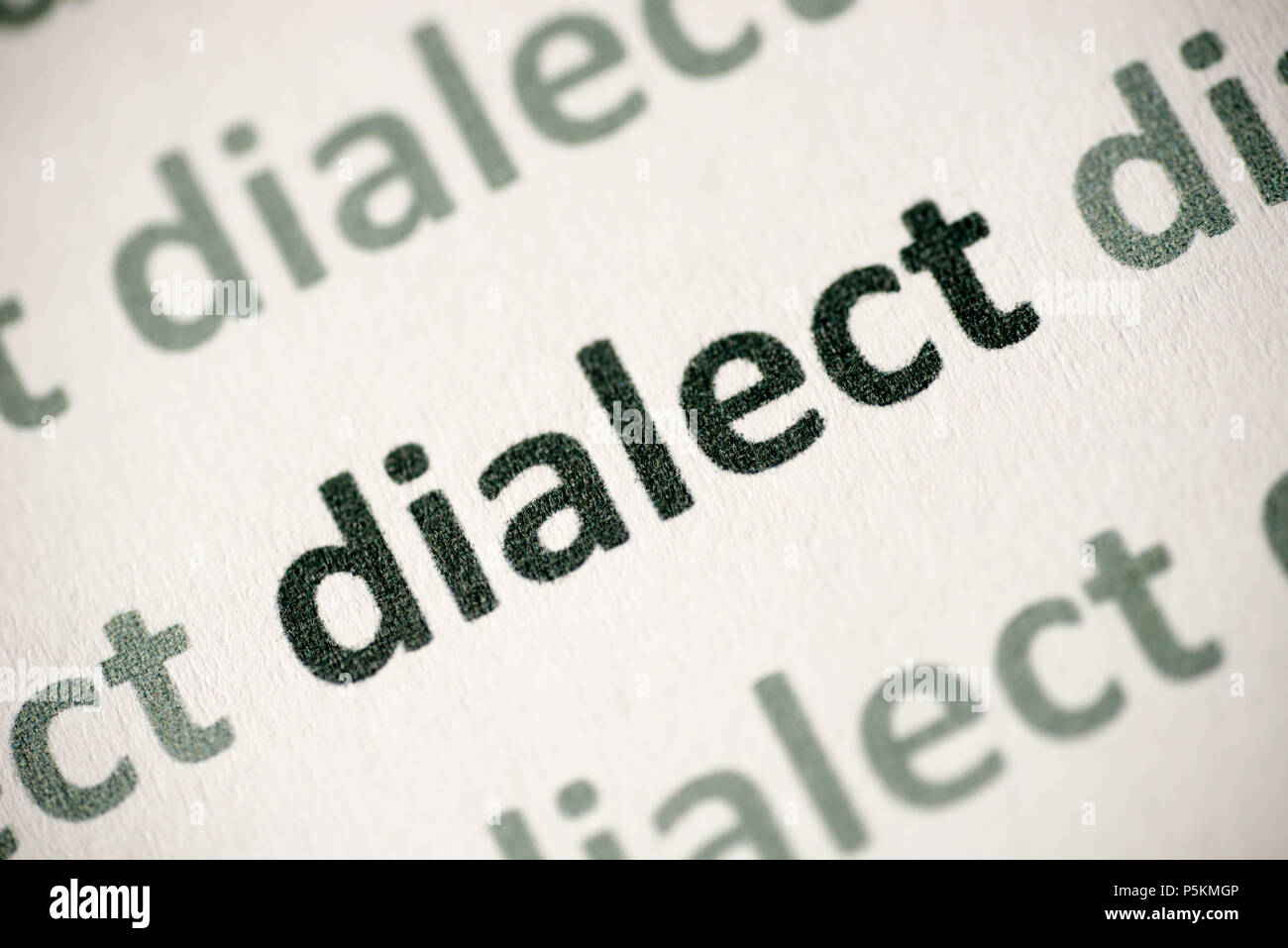 word dialect printed on white paper macro Stock Photo