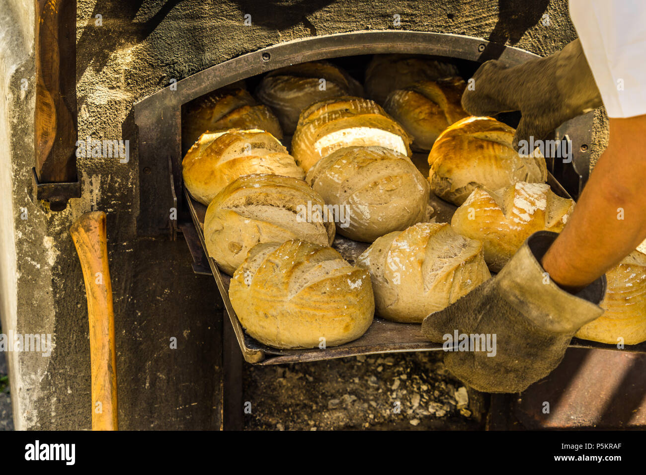 Freshly baked bread on a baking tray at an oven with firewood, Germany  Stock Photo - Alamy
