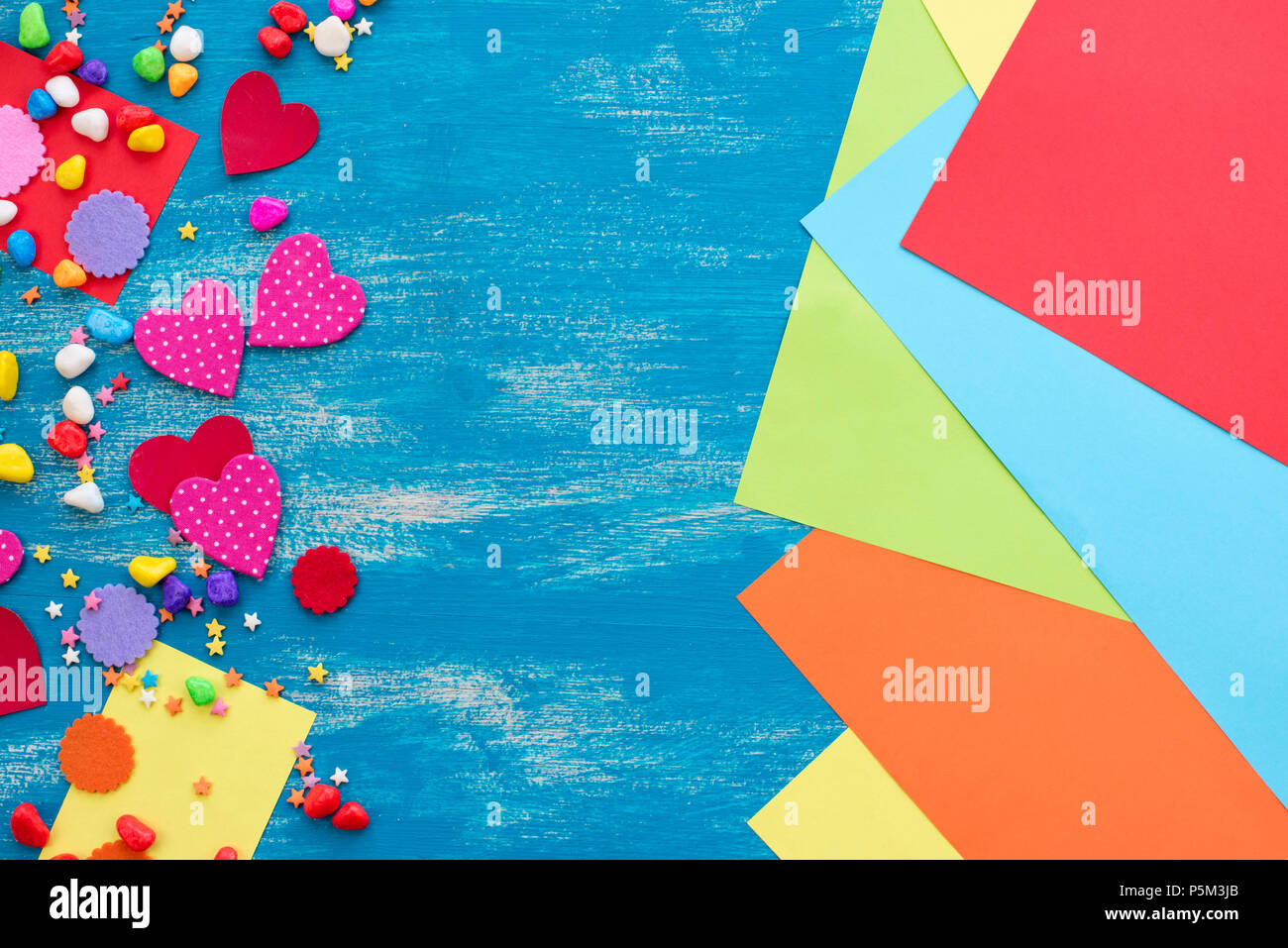 Festive confetti background heart candy color saturated. Wood old blue background with copy space flat lay Stock Photo