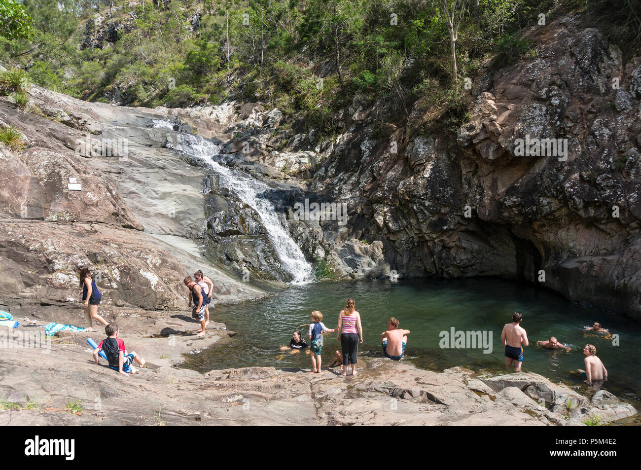 Families swimming in a rock pool, enjoying the Australian outdoor life, at Cedar Creek Falls, Tamborine National Park, Queensland Stock Photo
