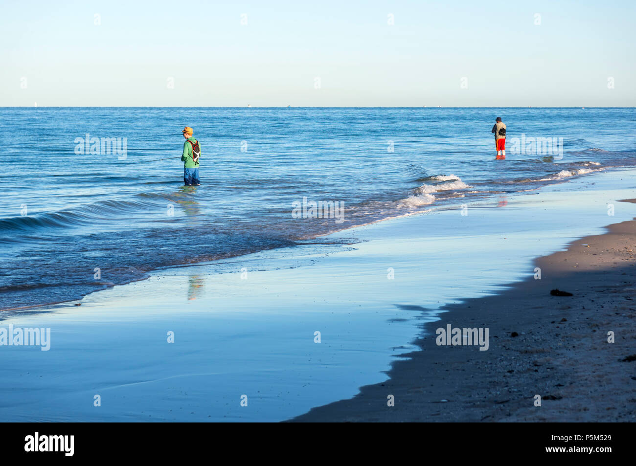 Early morning fishing by two men at Henley Beach, South Australia Stock Photo