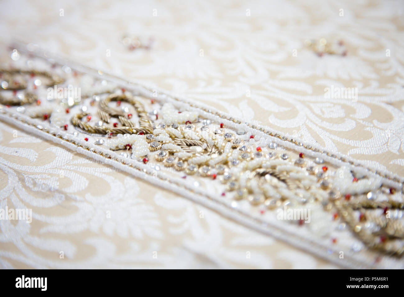 White indian fabric with embroideries closeup Stock Photo