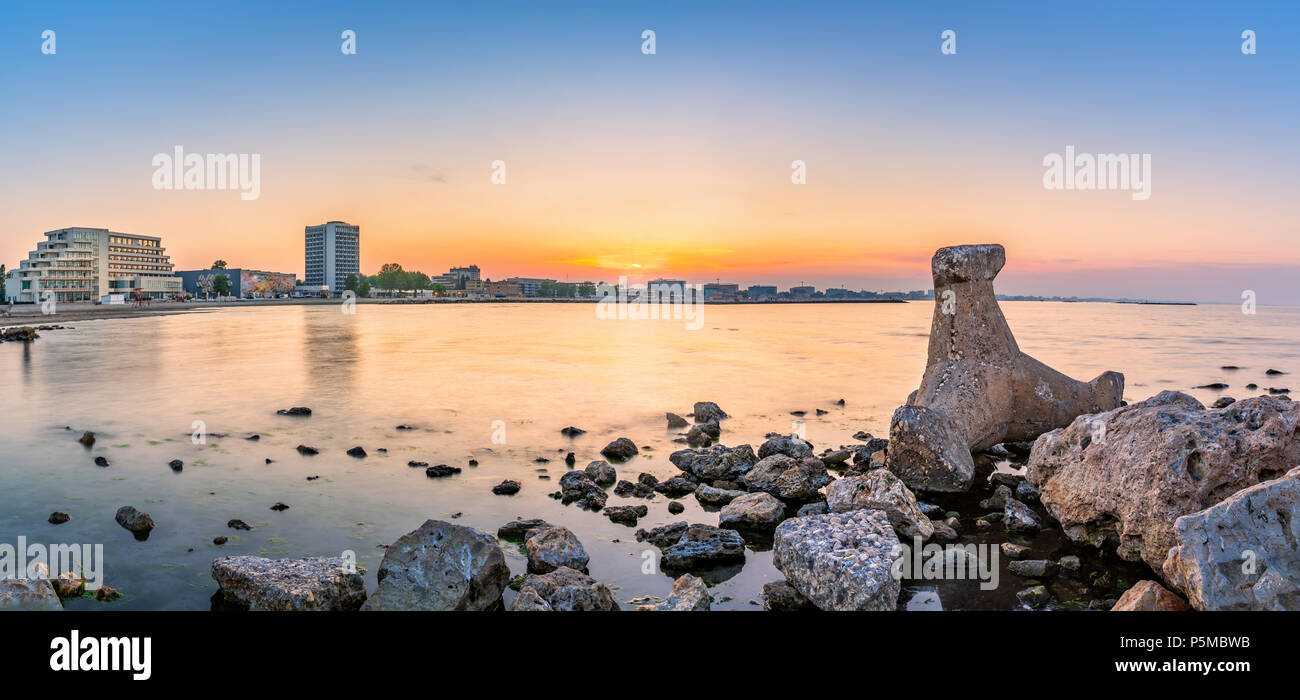 Black Sea shoreline panorama with Mamaia beach resort skyline at sunset, in Romania Stock Photo