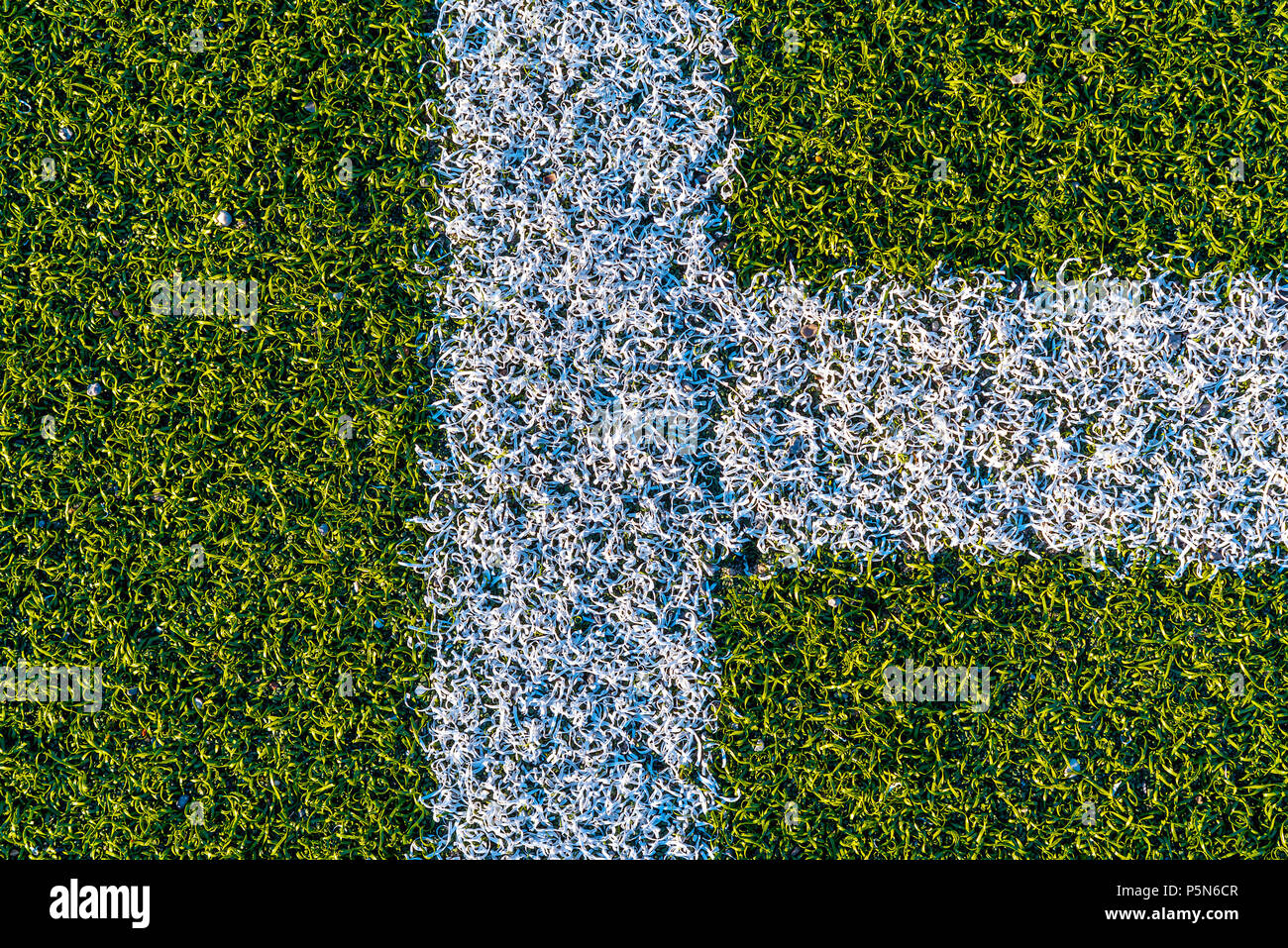 Background from  white lines on a green artificial football field Stock Photo