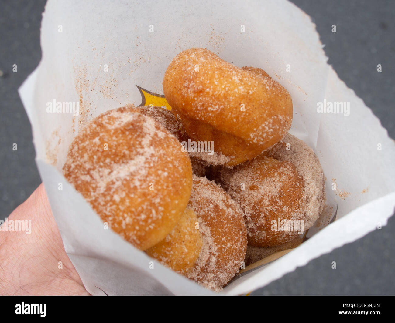 Holding A Bag Of Sugar Covered Mini Donuts Stock Photo