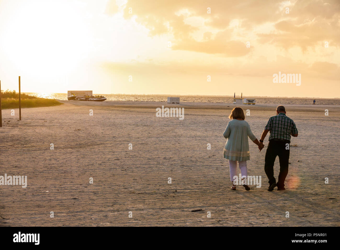 Florida,Gulf of Mexico,Fort Ft. Myers Beach,sand,beach,man men male,woman female women,couple,holding hands,walking,mature,romantic,FL170925079 Stock Photo